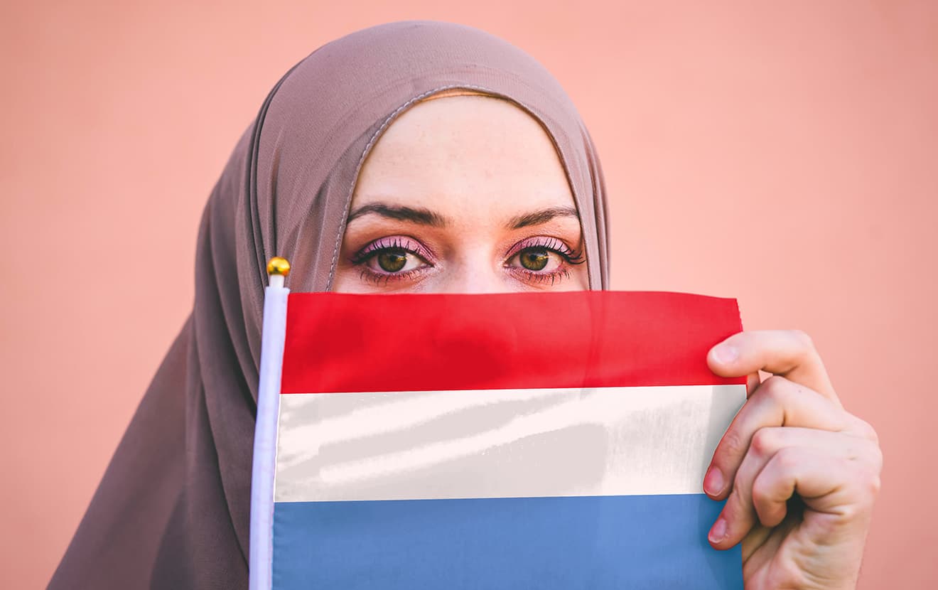 Muslim woman in hijab holds flag of Luxembourg