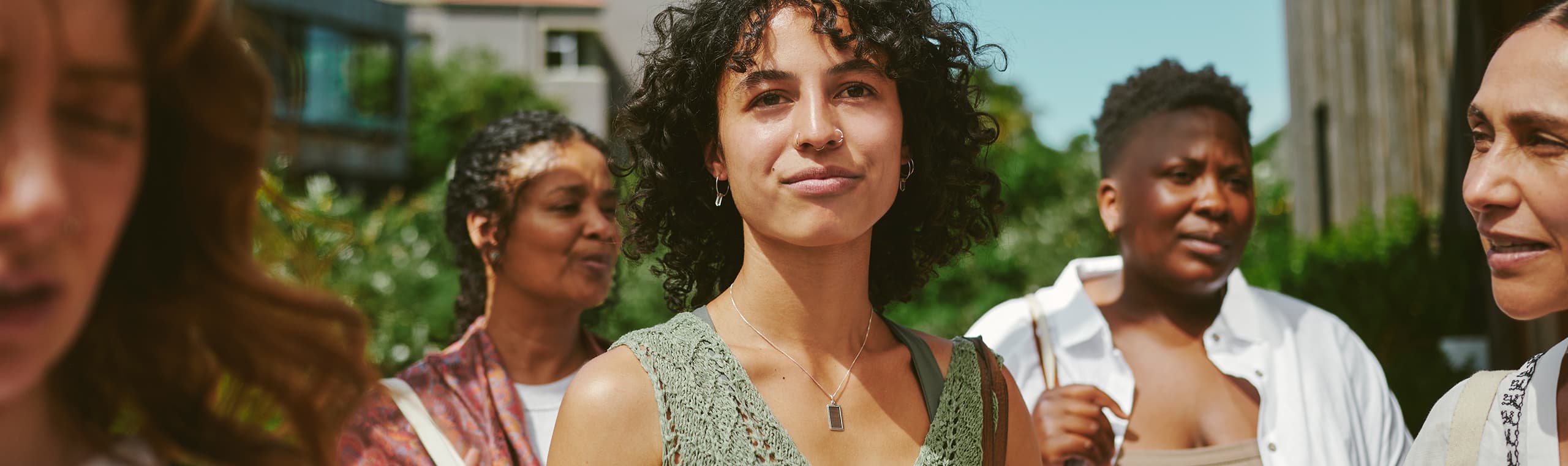 Young woman standing with friends after a yoga class at a wellness retreat