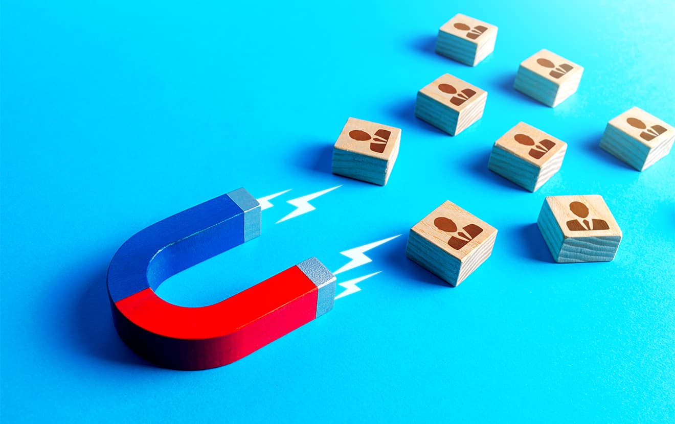 Magnet attracts blocks to people. Recruiting new workers. Search for specialists and professionals. Brain drain to developed countries through educational grants. Business team building.
