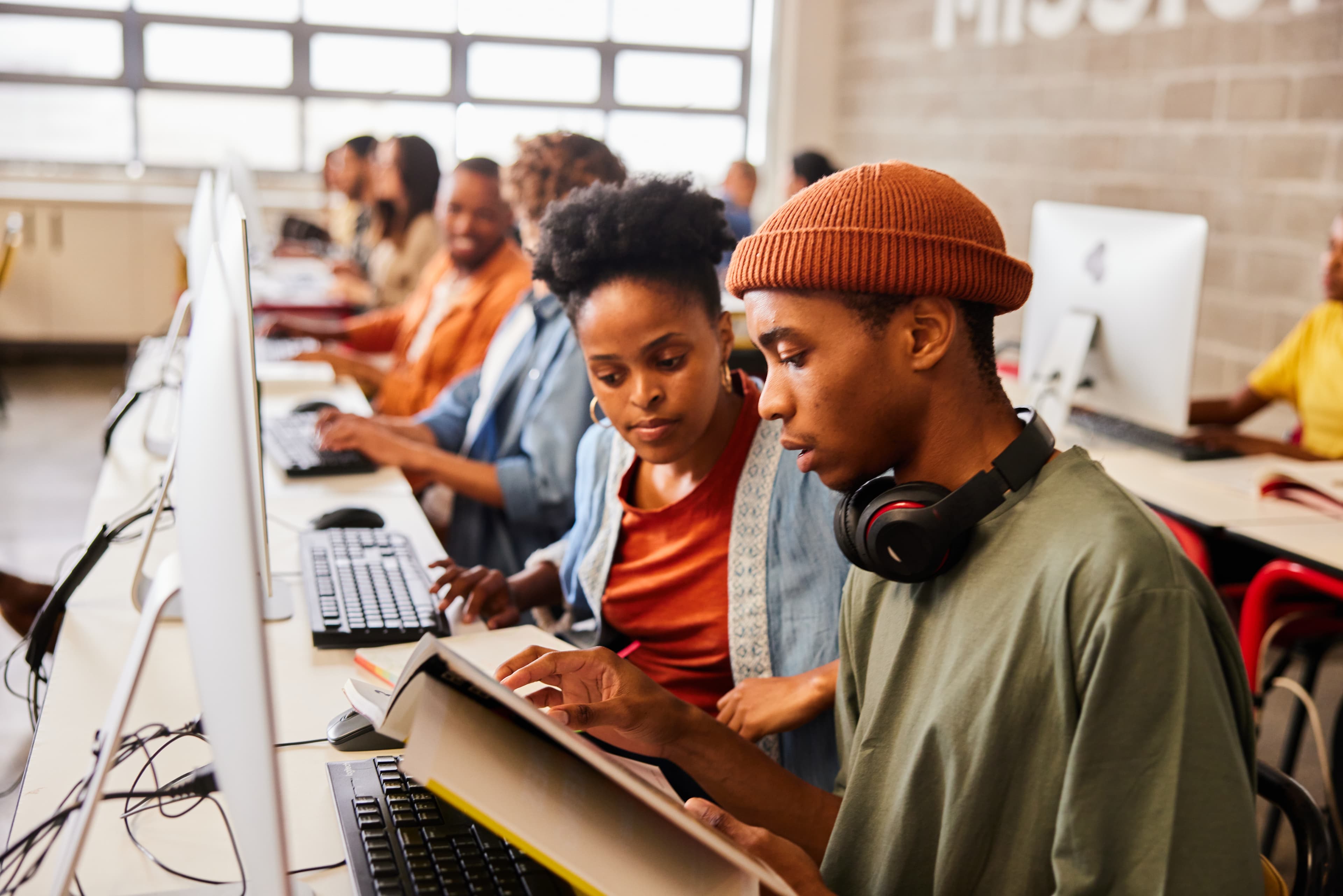 Dark skin students studying in front of computers at university campus - CAIPD Supports Evidence-Based Cooperation Policy in Cabo Verde - hero image