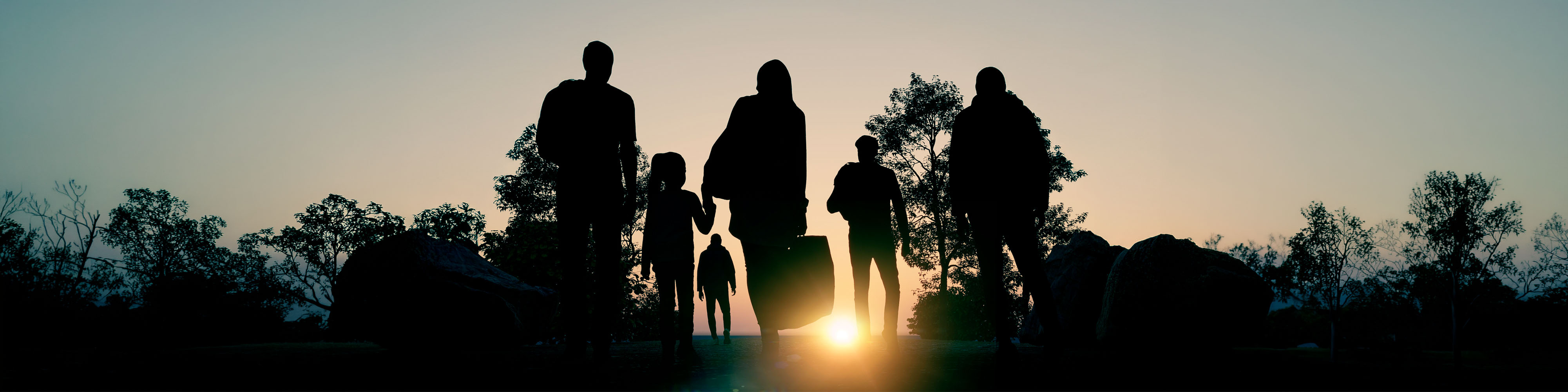 Migrants with luggage walking