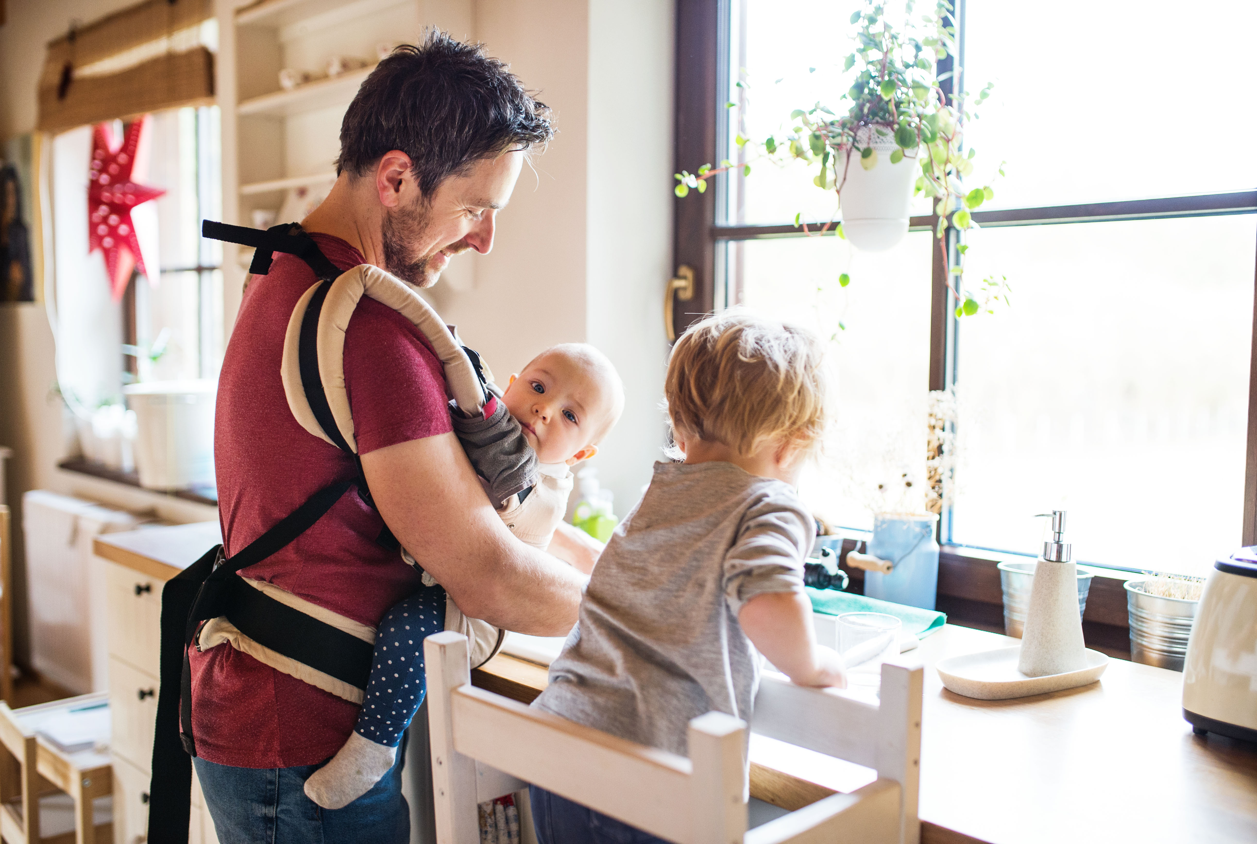Dad holding his new born baby - Comparative Analysis of Parental Leave Best Practices - hero image
